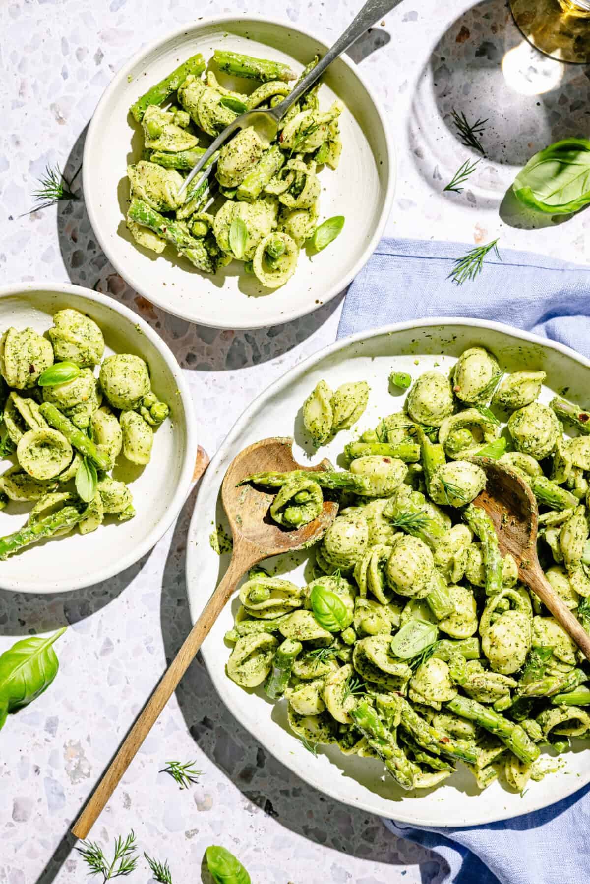 Green Goddess Pasta Salad in serving bowl and on two plates.